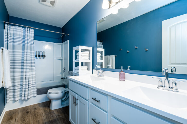 The shared upstairs bathroom has double sinks and storage for everyone.